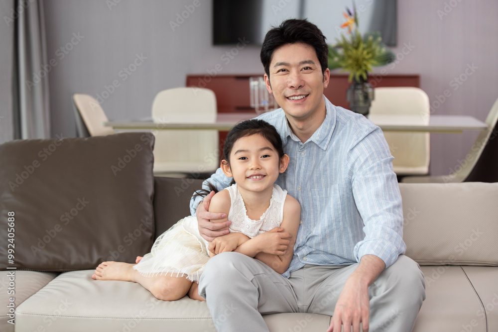 Father And Daughter Sitting On The Sofa Father And Daughter Sitting On The Sofa