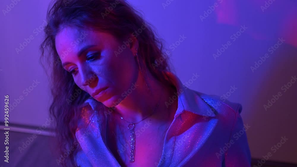 Close up portrait of lady looking to camera in red and blue neon lights Close up portrait of lady looking to camera in red and blue neon lights