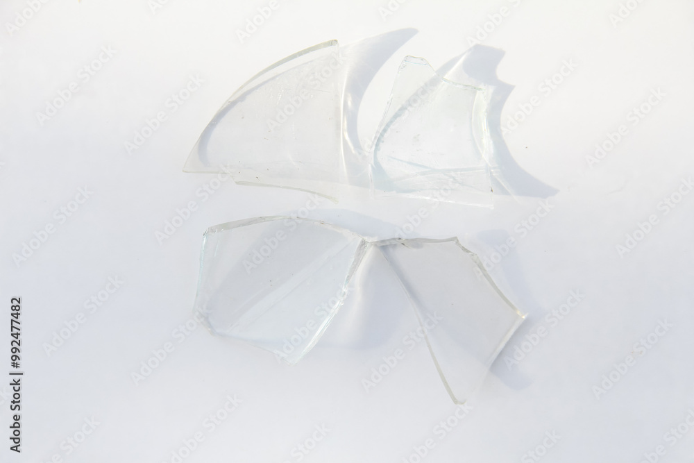 Broken glass or sharp shards of glass on a white background Broken glass or sharp shards of glass on a white background