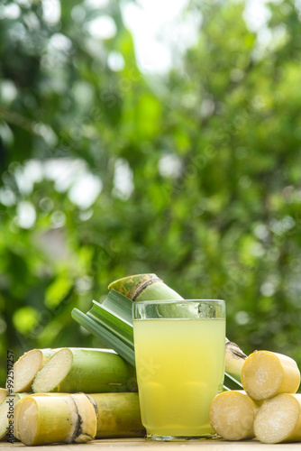 Drink from sugar cane juice, squeezed sugar cane juice with sugar cane stalks and natural background
