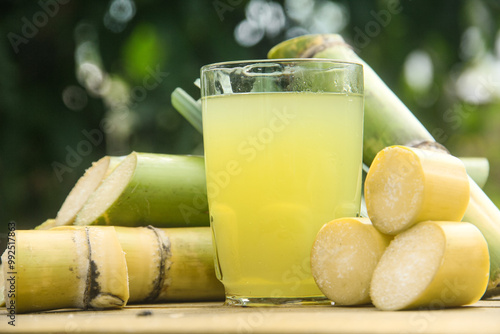 Drink from sugar cane juice, squeezed sugar cane juice with sugar cane stalks and natural background