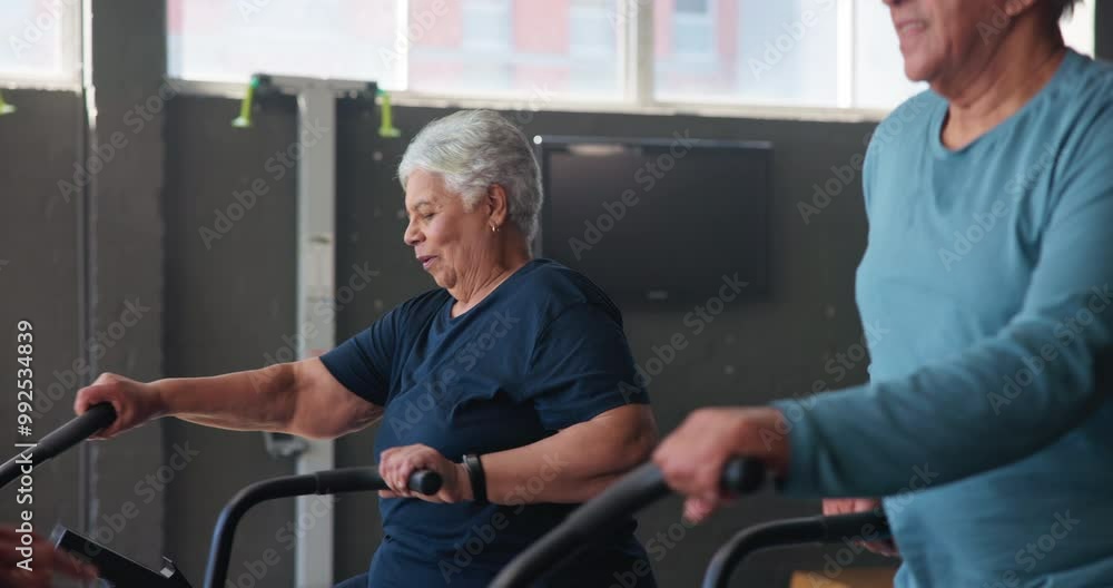 Mature people, fitness and exercise bike for endurance or challenge in class. Group, healthy and elliptical machine for cycling sports, workout and physical training in studio, gym or wellness center Mature people, fitness and exercise bike for endurance or challenge in class. Group, healthy and elliptical machine for cycling sports, workout and physical training in studio, gym or wellness center