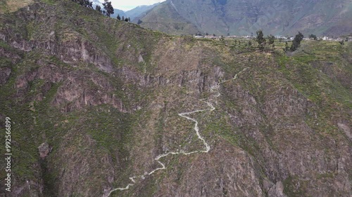 Aerial: Switchback footpath trail leads into steep Colca Canyon, Peru photo