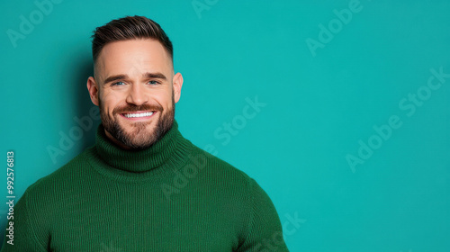 A cheerful man in a green sweater smiles against a blue background, radiating happiness and warmth. Perfect for lifestyle ads