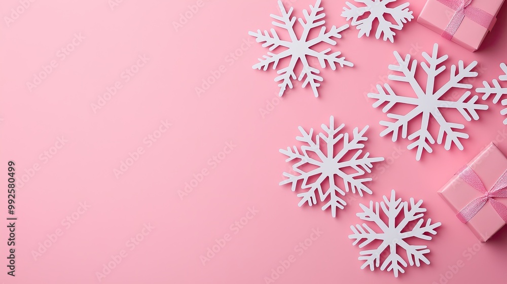 A festive arrangement of white snowflakes and pink gifts on a soft pink background, creating a cheerful holiday atmosphere. A festive arrangement of white snowflakes and pink gifts on a soft pink background, creating a cheerful holiday atmosphere.