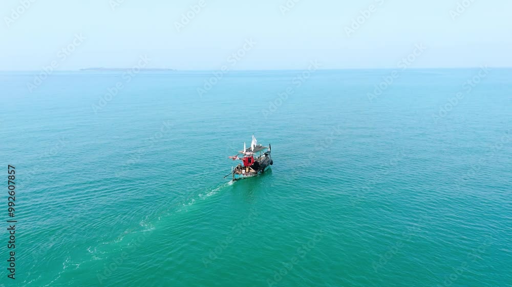 Drone view of small boat in the middle of beautiful calm blue sea Drone view of small boat in the middle of beautiful calm blue sea