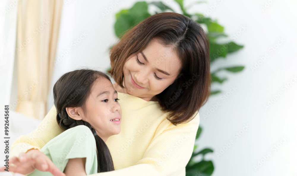 Parent and child, Asian mother enjoying with daughter in living room at home
Parent and child, Asian mother enjoying with daughter in living room at home