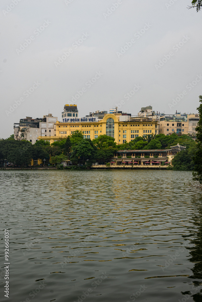 Fototapeta premium Hanoi Vietnam, yellow buildings at the Hoan Kiem Lake in Hanoi city outdoor at daytime.