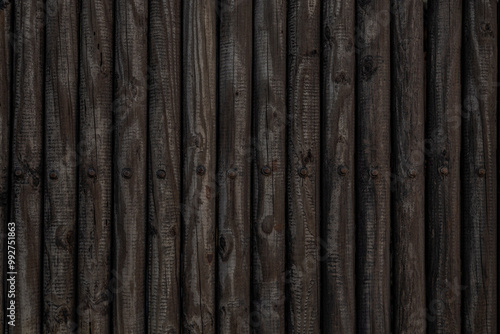 Log wood fence wall background. Old weathered wooden logs. Horizontal photo of Natural repeated wood plank pattern