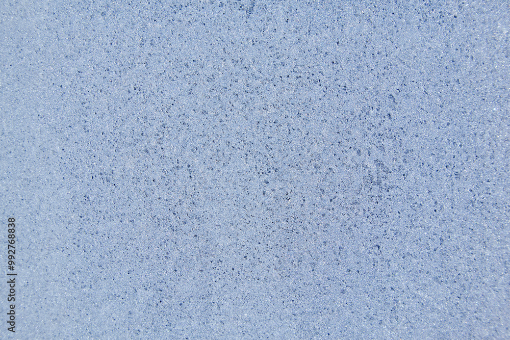 Fototapeta premium Frost patterns on frozen glass on a winter day. Winter frosty texture natural background