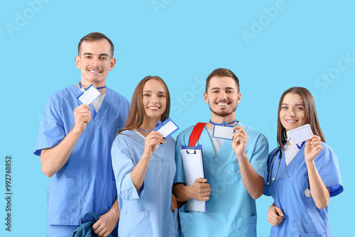 Group of medical students with badges on blue background