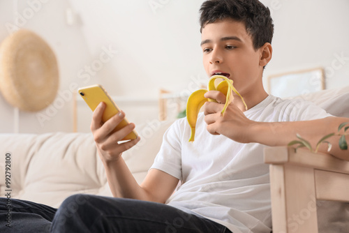 Teenage boy with mobile pho...