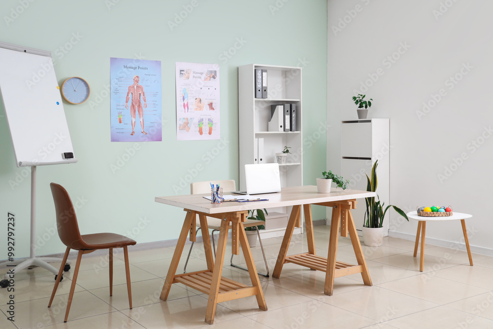 Workplace of osteopath with laptop in rehabilitation center Workplace of osteopath with laptop in rehabilitation center