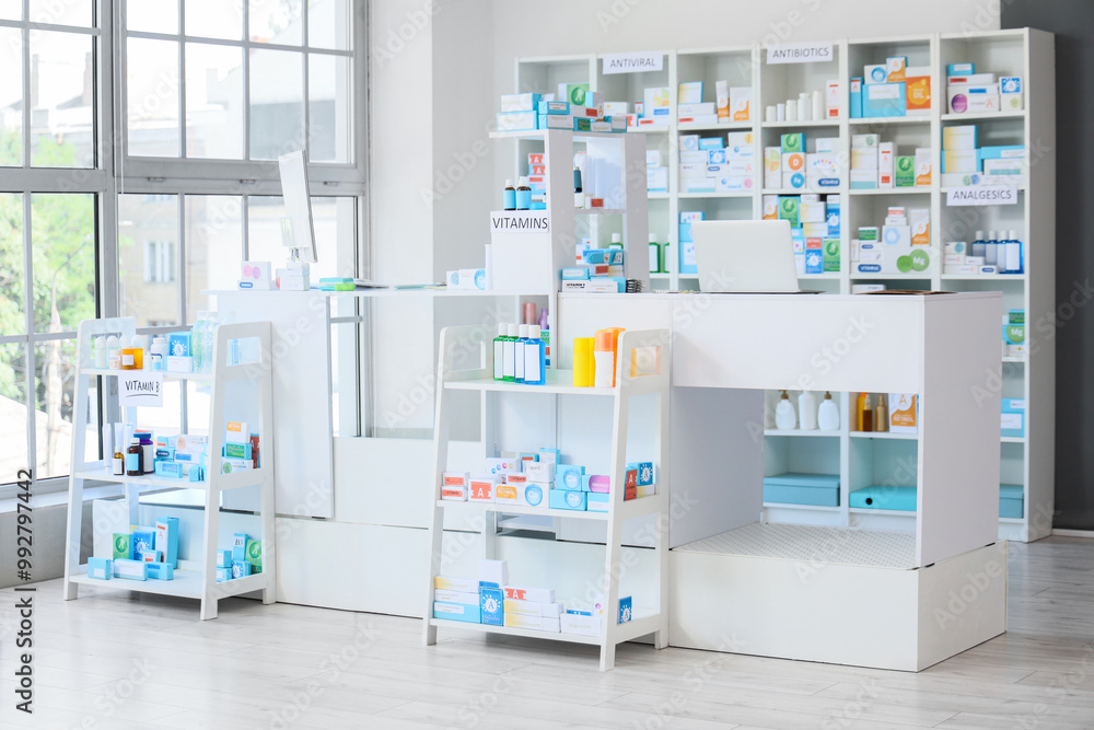 Interior of pharmacy with counter, shelf unit and medications Interior of pharmacy with counter, shelf unit and medications
