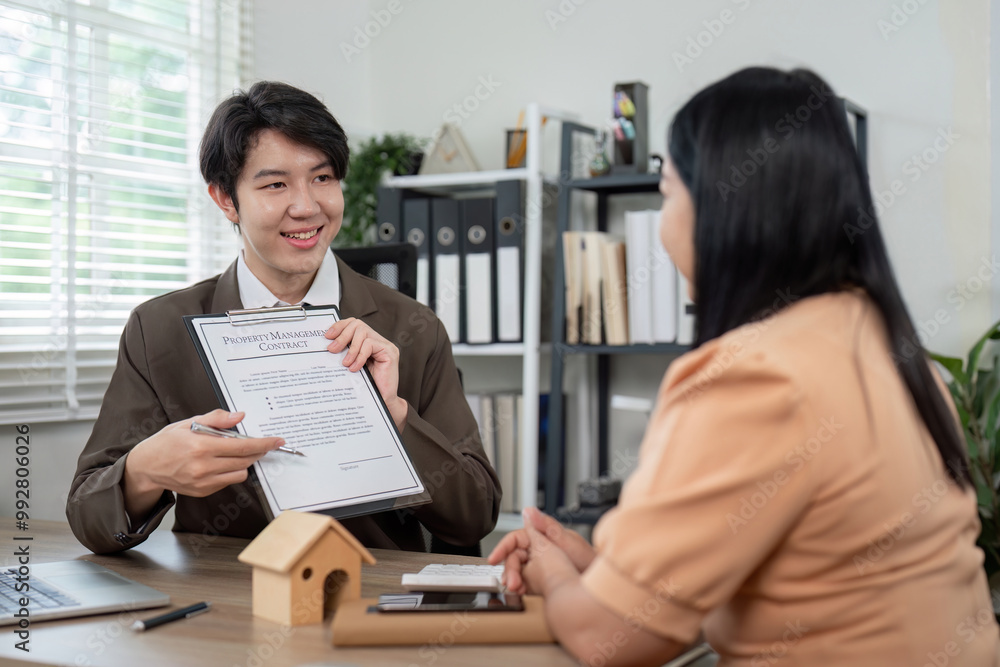 Real Estate Agent Explaining Property Contract to Engaged Client for Transparency Real Estate Agent Explaining Property Contract to Engaged Client for Transparency