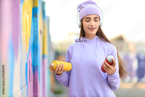 Teenage girl with spray pai...