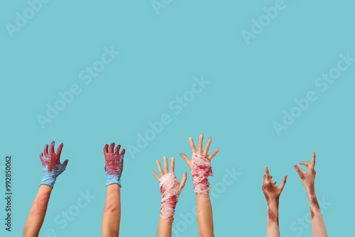 Hands of scary zombies on color background. Halloween celebration