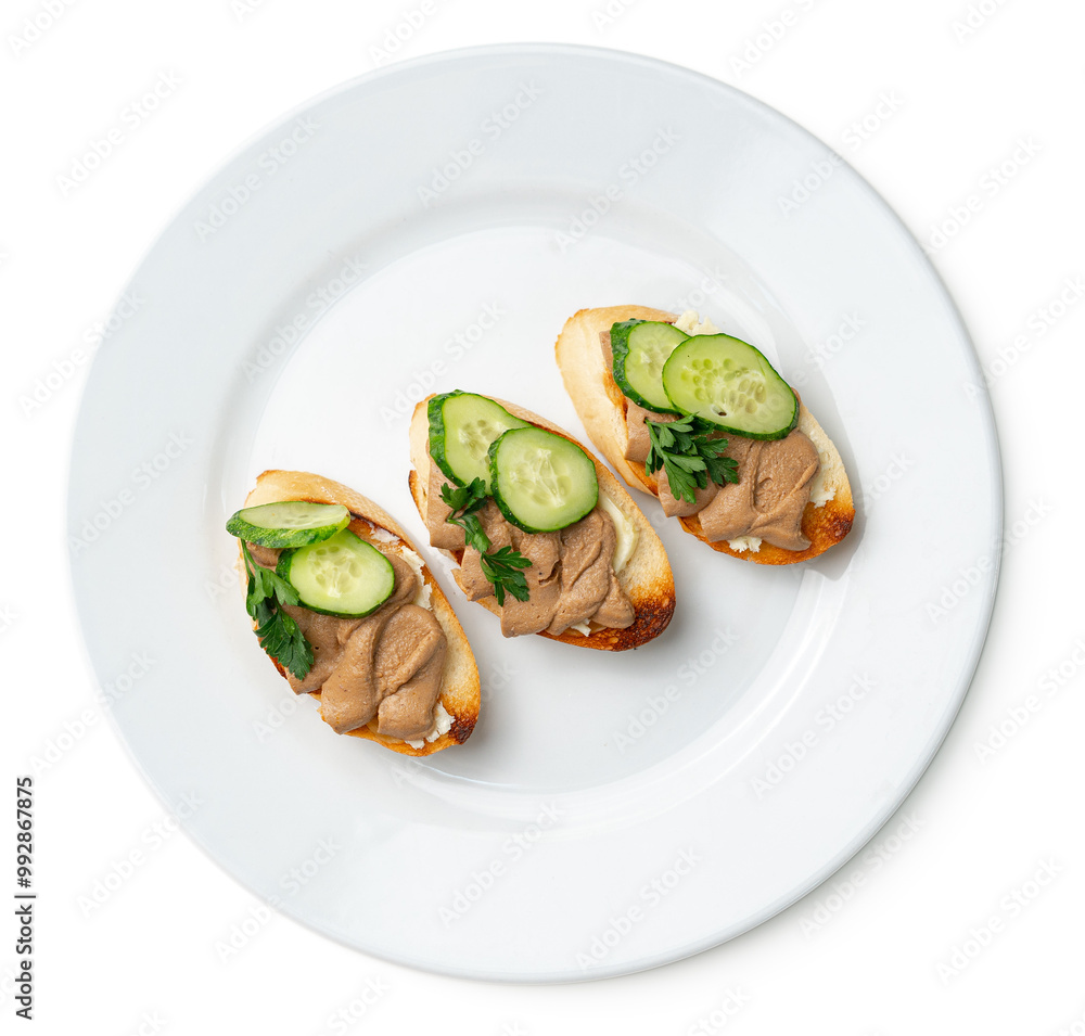 Savory canapes topped with creamy spread and cucumber slices served Savory canapes topped with creamy spread and cucumber slices served
