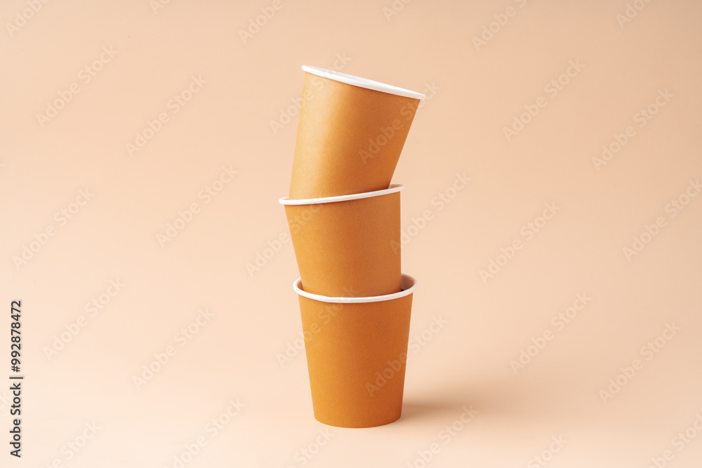 Paper cups stacked on a neutral background for a visually appealing display Paper cups stacked on a neutral background for a visually appealing display