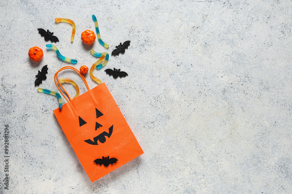 Obraz premium Shopping bag with Halloween candies on grunge white background