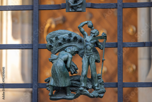 Figurines on metal fence of the Golden Gate of medieval St. Vitus Cathedral, Prague, Czech Republic