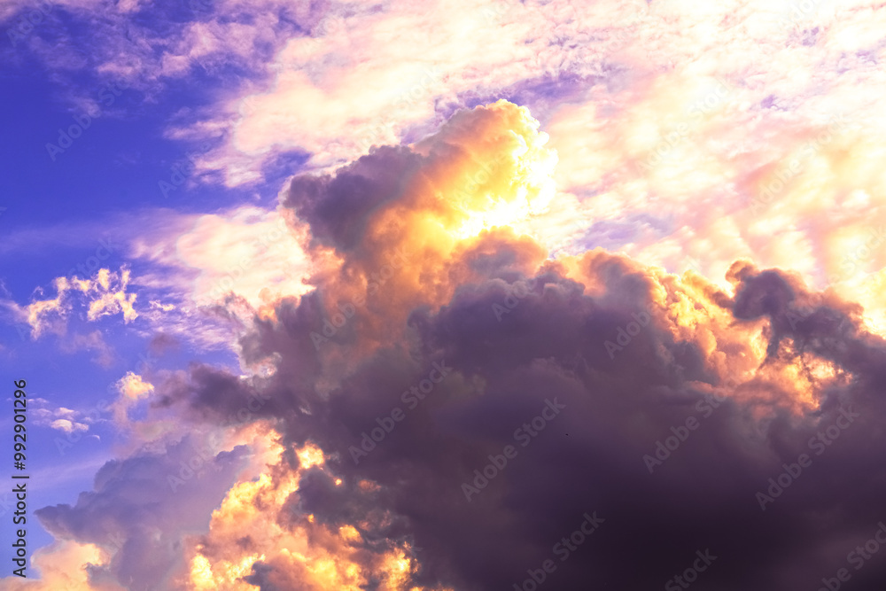 Dramatic sunset paints the sky with vibrant shades of orange, pink, and dark purple, silhouetting buildings below and creating a breathtaking evening scene full of depth and color.