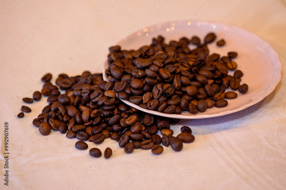 A pile of coffee beans spilled on the table A pile of coffee beans spilled on the table