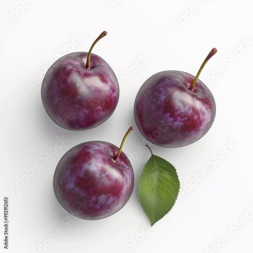 Three plums with a green leaf on a white background.