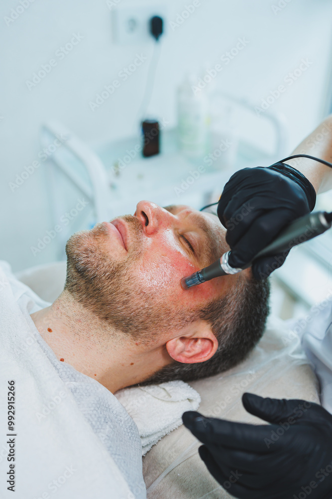 Fototapeta premium Male cosmetology in a beauty salon. A man takes care of his facial skin.