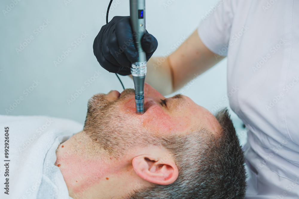 Male cosmetology. A man lies at a cosmetologist for a facial treatment. Male cosmetology. A man lies at a cosmetologist for a facial treatment.