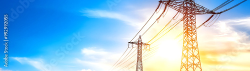 Power lines silhouetted against a vibrant sunset sky, showcasing the intersection of nature and technology in energy distribution.