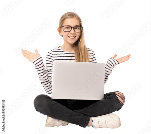 Smiling beautiful young girl wearing glasses sitting on floor using computer isolated over transparent background. Technology concept.