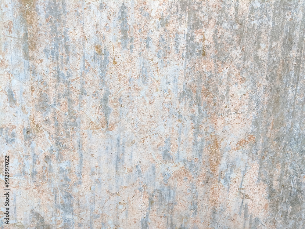 Weathered surface with vertical streaks and faded spots in light gray and beige tones. The textured wall showcases signs of aging, roughness, and subtle color variations in an abstract pattern. Weathered surface with vertical streaks and faded spots in light gray and beige tones. The textured wall showcases signs of aging, roughness, and subtle color variations in an abstract pattern.