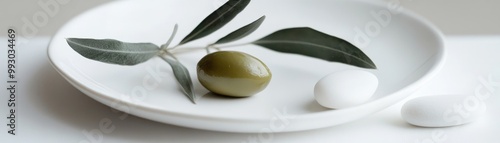 Olive Branch and White Stones on a Plate, minimalism, still life
