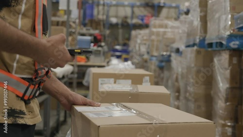 Warehouse worker scanning package box