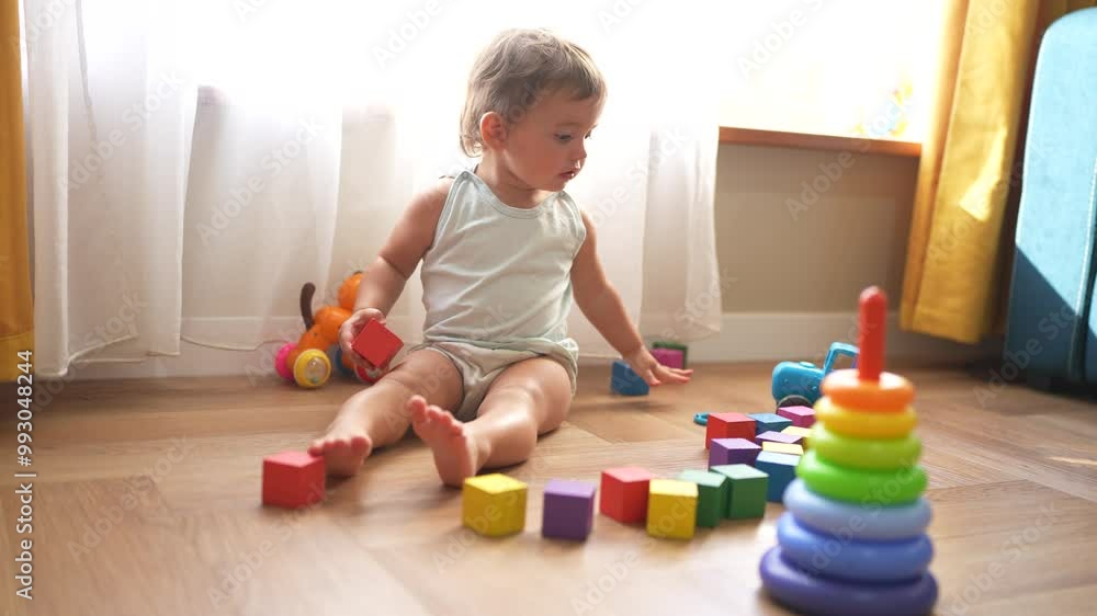 baby plays with toys cubes. kindergarten a teaching children kid dream concept. baby on the floor of the house plays with a lifestyle pyramid and cubes toys development of fine motor skills baby plays with toys cubes. kindergarten a teaching children kid dream concept. baby on the floor of the house plays with a lifestyle pyramid and cubes toys development of fine motor skills