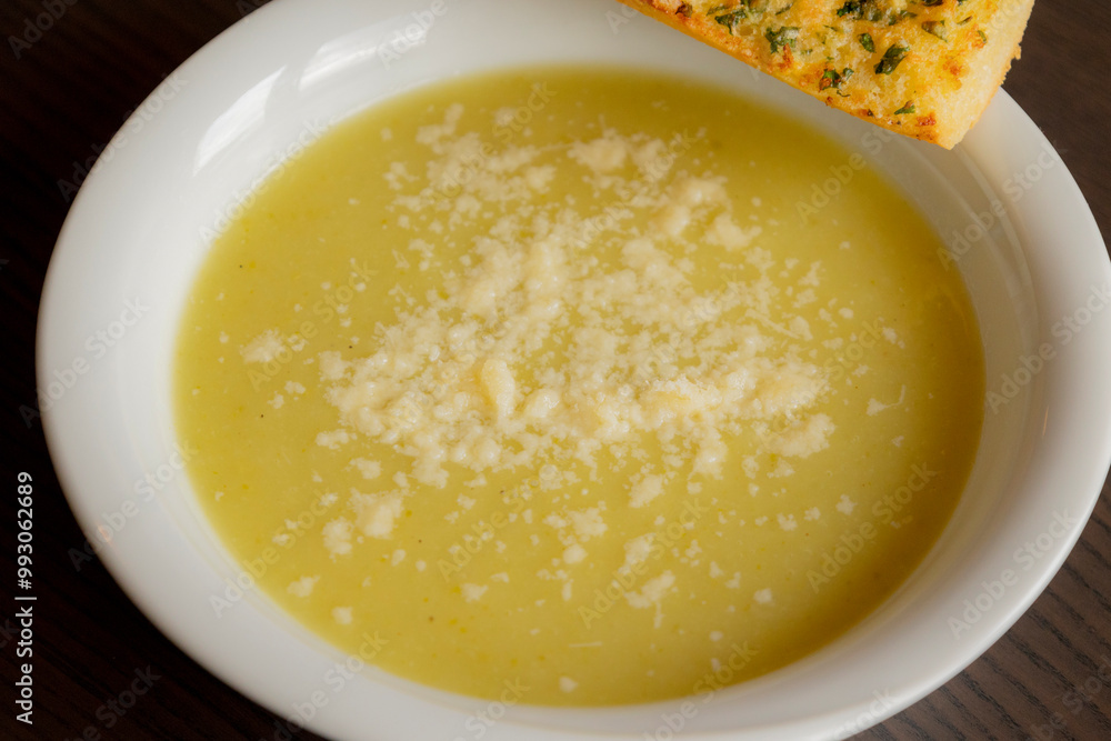 Zucchini Cream Soup with Parmesan and Garlic Bread Close-Up on Dark Background Zucchini Cream Soup with Parmesan and Garlic Bread Close-Up on Dark Background