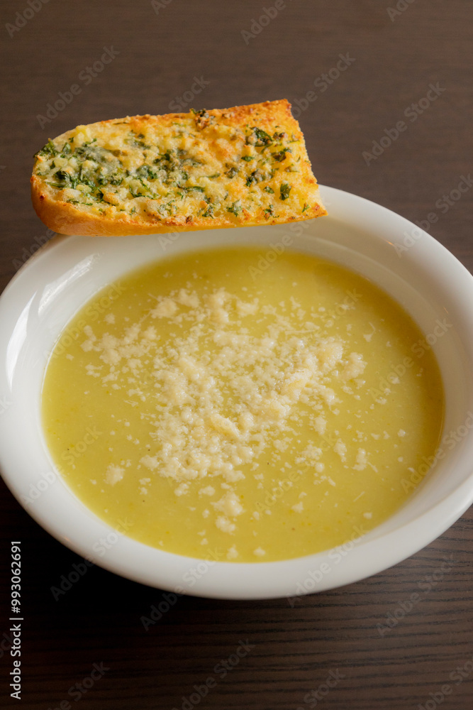 Zucchini Cream Soup with Parmesan and Garlic Bread Close-Up on Dark Background Zucchini Cream Soup with Parmesan and Garlic Bread Close-Up on Dark Background