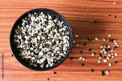 Split Black Lentil Also Know as Black Gram, Black Urad Dal, Vigna Mungo, Urad Bean on brown wooden Background
