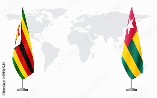 Zimbabwe and Togo flags for official meeting against background of world map.