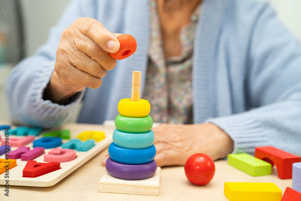Alzheimer disease AD, Asian elderly woman patient suffering from dementia learn practical motor skills rehabilitation. Alzheimer disease AD, Asian elderly woman patient suffering from dementia learn practical motor skills rehabilitation.