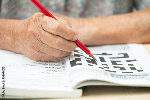 Bangkok, Thailand September 1, 2022 Alzheimer disease AD, Asian elderly woman playing sudoku puzzle game to practice for dementia prevention. photo