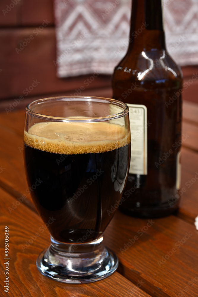 Dark beer in a glass on a table in a restaurant