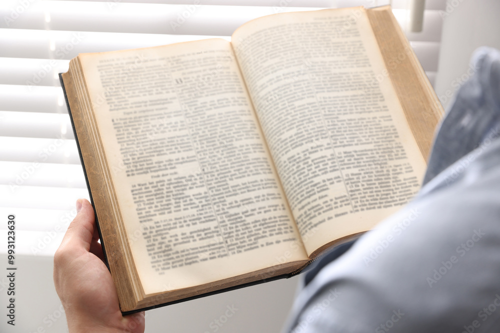 Obraz premium Man with Bible indoors, closeup. Christian faith