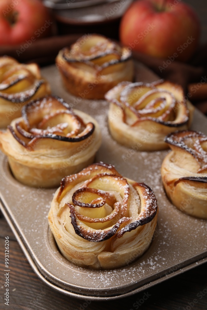 Freshly baked apple roses on wooden table, closeup. Puff pastry Freshly baked apple roses on wooden table, closeup. Puff pastry