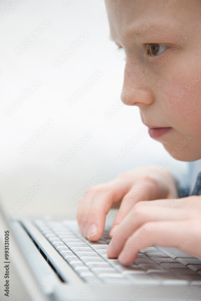 Extreme close up of a boy typing on laptop computer keyboard
Extreme close up of a boy typing on laptop computer keyboard