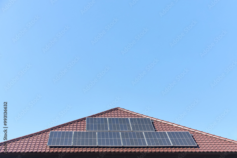 Solar panels on roof with copyspace. Building with lots of solar panels. Renewable solar energy. Alternative Generator Energy efficient house uses solar energy of sun. Solar panels on roof with copyspace. Building with lots of solar panels. Renewable solar energy. Alternative Generator Energy efficient house uses solar energy of sun.