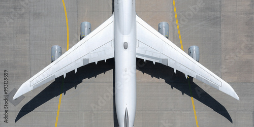 View from above white airplane on sunny airport tarmac
