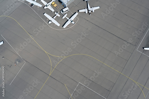 View from above propellor airplanes and lines on airport tarmac

