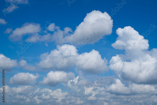 Beautiful blue sky with white clouds forming on sunny day photo